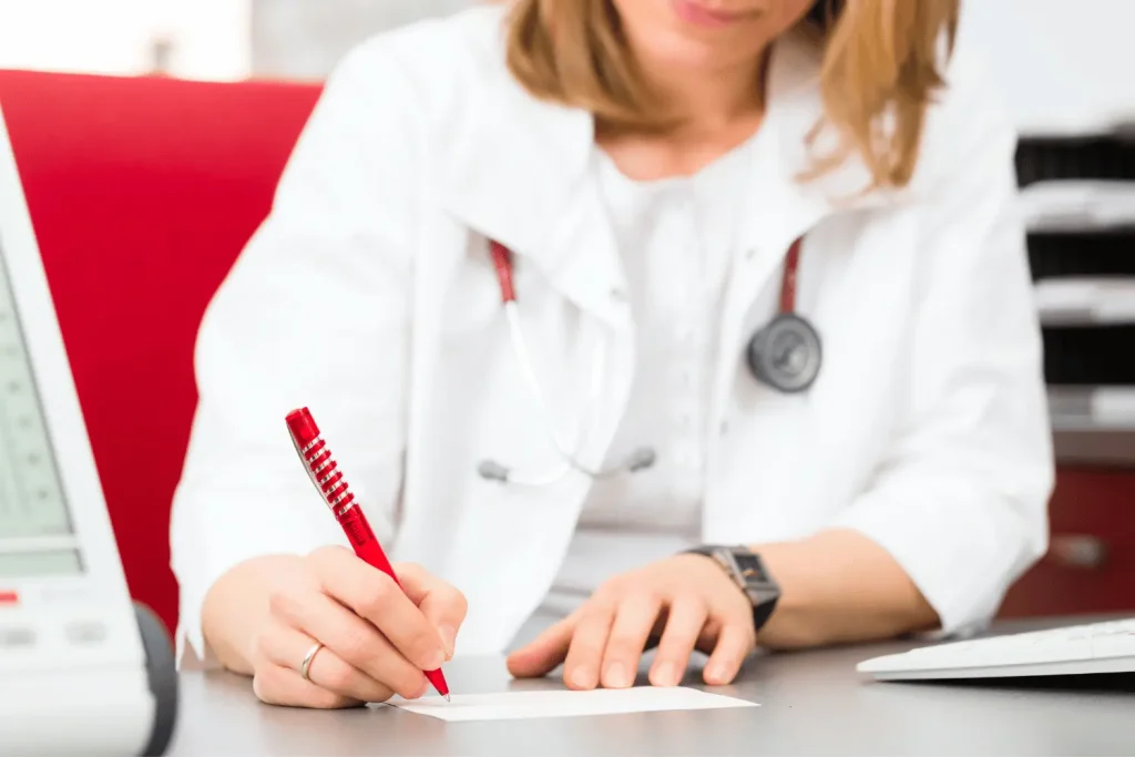 A doctor writing a medical certificate